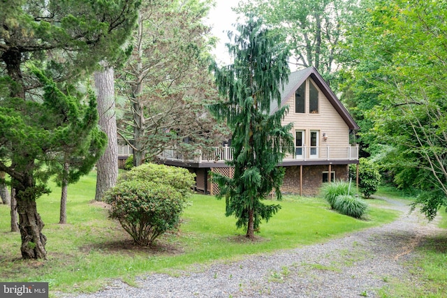 26747 Cat Creek Rd, Mechanicsville, MD 20659 - view of side of home with stone siding, a lawn, a deck, and driveway