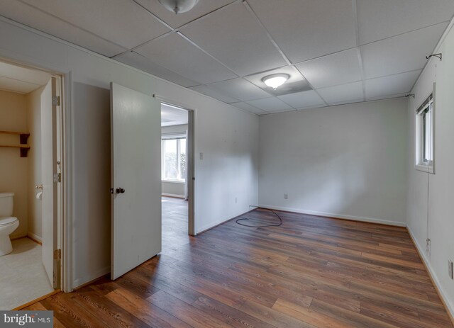26747 Cat Creek Rd, Mechanicsville, MD 20659 - spare room with wood finished floors, a drop ceiling, and baseboards