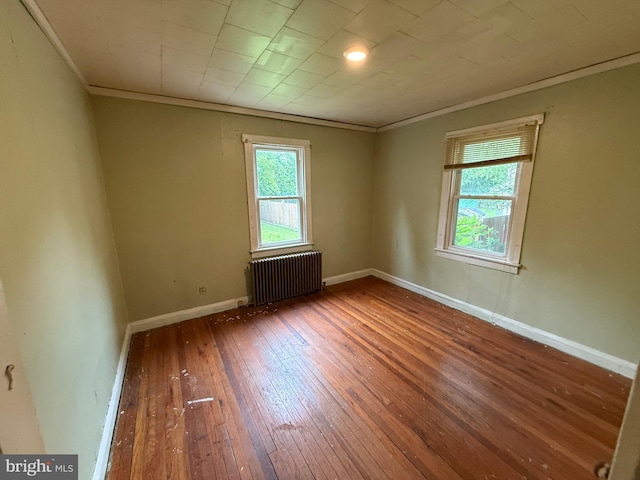 3602 Tulip Ave, Baltimore, MD 21227 - unfurnished room featuring radiator, crown molding, wood-type flooring, and baseboards