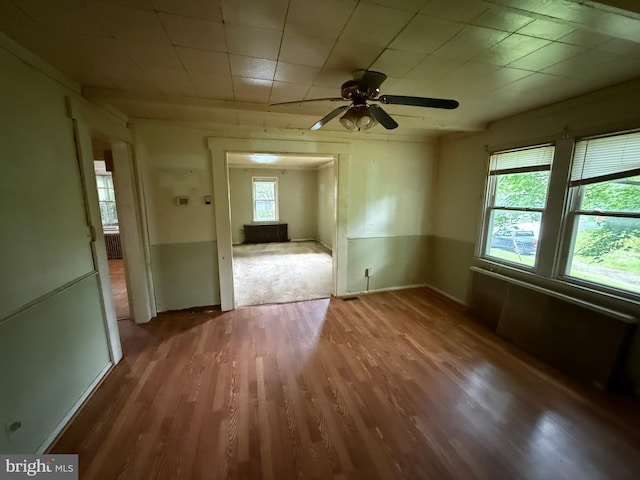 3602 Tulip Ave, Baltimore, MD 21227 - empty room with healthy amount of natural light, wood finished floors, and ceiling fan