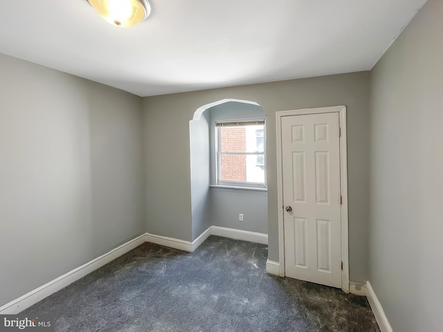 1507 E Duval St, Philadelphia, PA 19138 - empty room with arched walkways, dark colored carpet, and baseboards