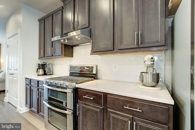 3409 Stone Barn Dr, Frederick, MD 21704 - kitchen with double oven range, ventilation hood, dark brown cabinets, and light wood-type flooring