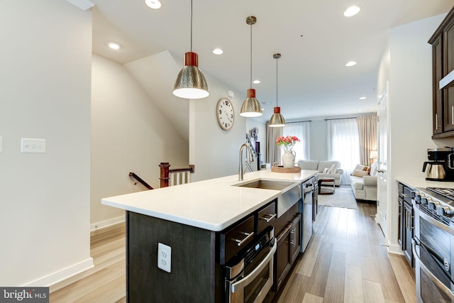 3409 Stone Barn Dr, Frederick, MD 21704 - kitchen with open floor plan, a sink, light wood-style floors, recessed lighting, and light countertops