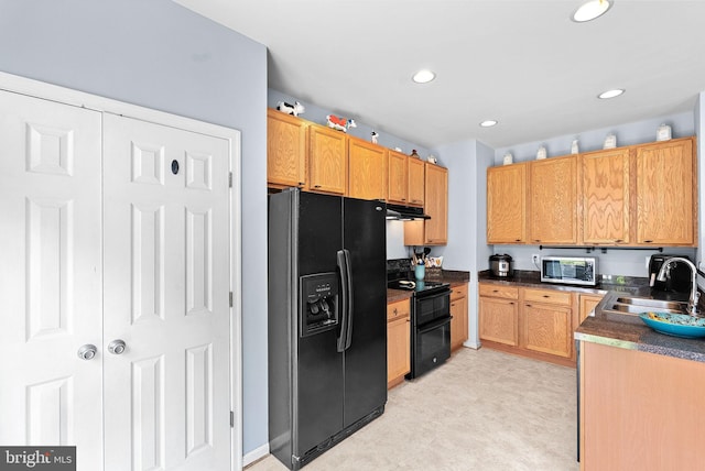 15673 Mendoza Ln, Woodbridge, VA 22191 - kitchen featuring black appliances, dark countertops, recessed lighting, and light floors