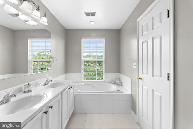 15673 Mendoza Ln, Woodbridge, VA 22191 - bathroom featuring a garden tub, plenty of natural light, tile patterned flooring, and double vanity