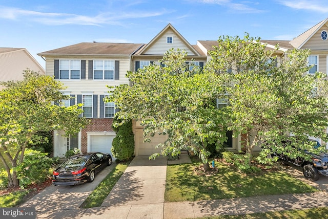 15673 Mendoza Ln, Woodbridge, VA 22191 - townhome / multi-family property with an attached garage, driveway, and brick siding