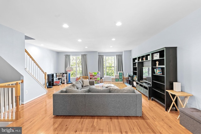 15673 Mendoza Ln, Woodbridge, VA 22191 - living room featuring light wood-style floors, recessed lighting, and stairs
