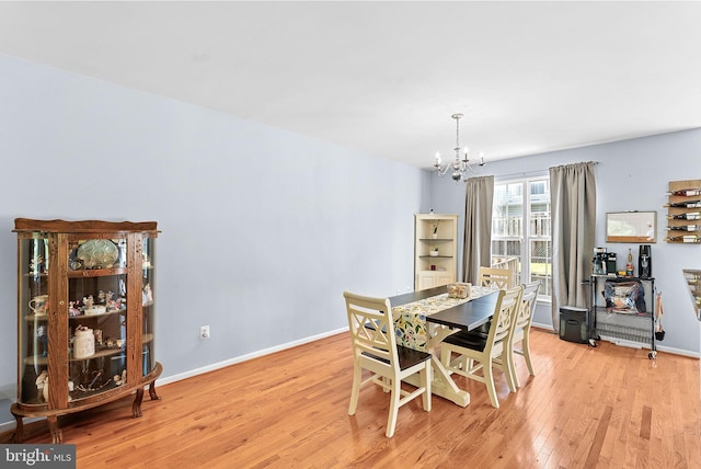 15673 Mendoza Ln, Woodbridge, VA 22191 - dining space with a chandelier and light wood-type flooring