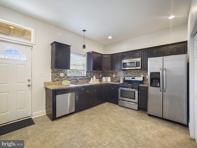 1705 E Chase St, Baltimore, MD 21213 - kitchen with appliances with stainless steel finishes, tasteful backsplash, a sink, light stone countertops, and recessed lighting