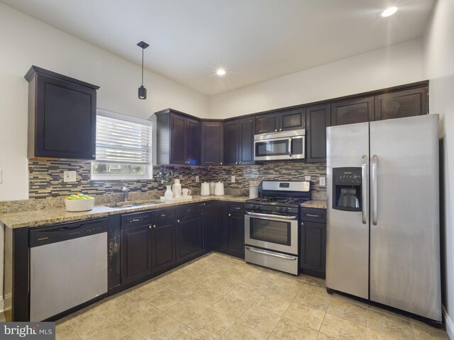 1705 E Chase St, Baltimore, MD 21213 - kitchen featuring stainless steel appliances, tasteful backsplash, light stone countertops, a sink, and recessed lighting