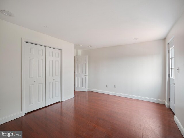 1705 E Chase St, Baltimore, MD 21213 - unfurnished bedroom featuring wood finished floors, baseboards, and a closet