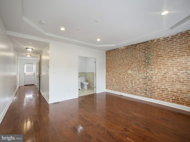 1705 E Chase St, Baltimore, MD 21213 - spare room with brick wall, hardwood / wood-style floors, baseboards, a raised ceiling, and recessed lighting