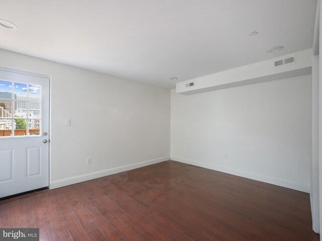 1705 E Chase St, Baltimore, MD 21213 - empty room featuring dark wood-type flooring and baseboards