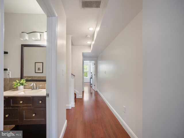 1705 E Chase St, Baltimore, MD 21213 - corridor featuring dark wood-style floors, baseboards, a sink, recessed lighting, and stairs