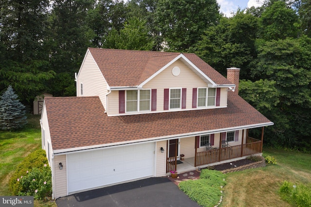 14 Saint Josephs Way, Schuylkill Haven, PA 17972 - view of front of home with covered porch, driveway, a chimney, a garage, and a front lawn