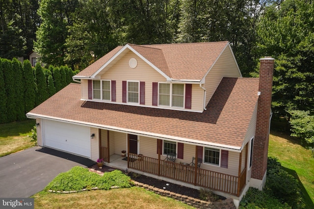 14 Saint Josephs Way, Schuylkill Haven, PA 17972 - view of front facade featuring covered porch, a chimney, driveway, a garage, and a front lawn