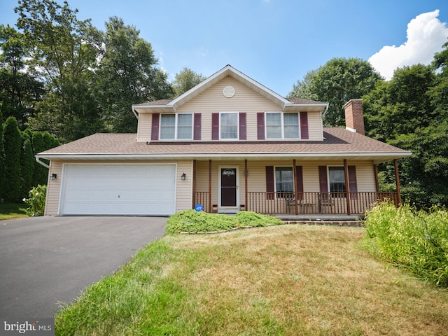 14 Saint Josephs Way, Schuylkill Haven, PA 17972 - view of front of home featuring asphalt driveway, a chimney, covered porch, a front lawn, and a garage