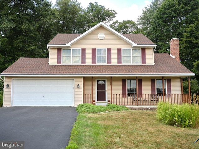 14 Saint Josephs Way, Schuylkill Haven, PA 17972 - view of front facade with asphalt driveway, a chimney, a front yard, a porch, and roof with shingles