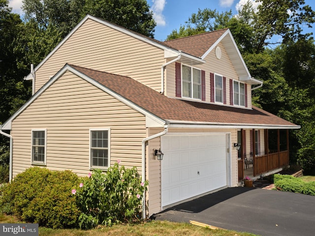 14 Saint Josephs Way, Schuylkill Haven, PA 17972 - view of front facade featuring a shingled roof, a porch, driveway, and a garage