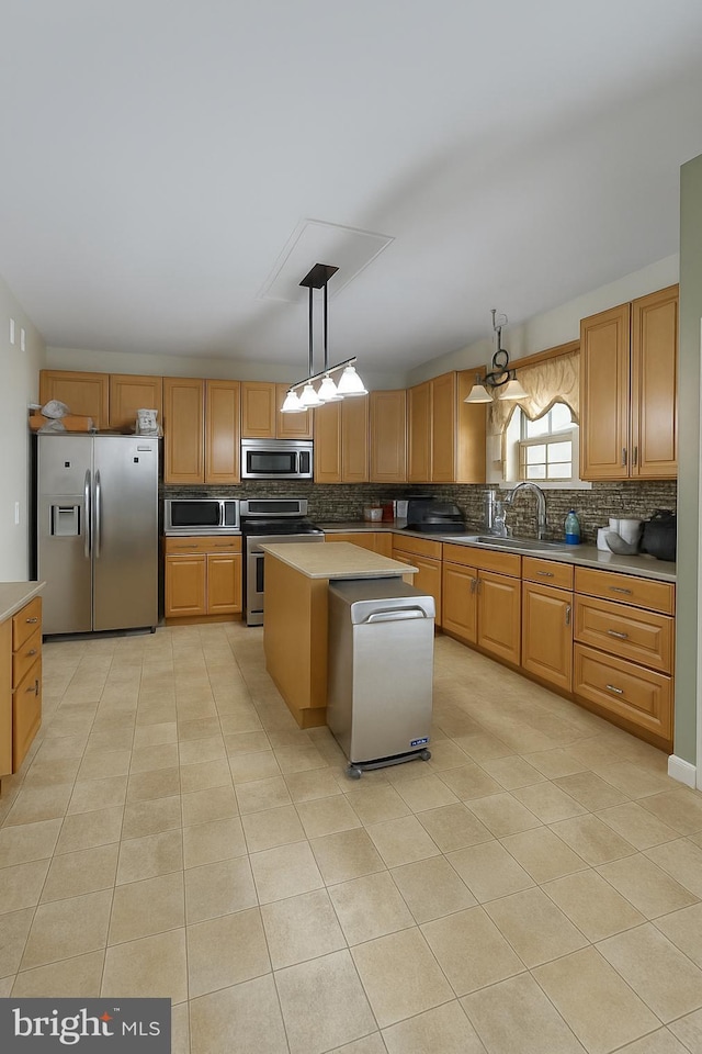 14 Riverside Rd, Dover, DE 19904 - kitchen featuring appliances with stainless steel finishes, light tile patterned floors, decorative backsplash, and pendant lighting