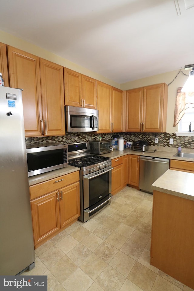 14 Riverside Rd, Dover, DE 19904 - kitchen featuring appliances with stainless steel finishes, decorative backsplash, and light countertops