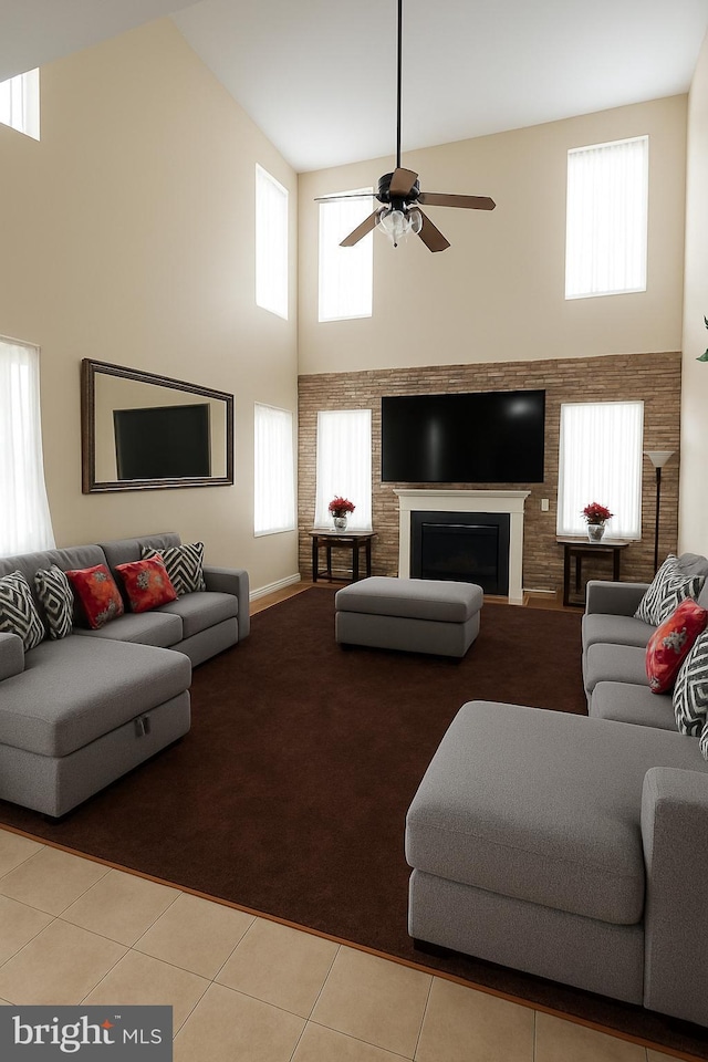 14 Riverside Rd, Dover, DE 19904 - living room featuring a towering ceiling, ceiling fan, a fireplace, light tile patterned floors, and light colored carpet