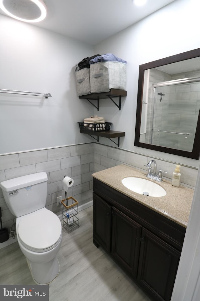 14 Riverside Rd, Dover, DE 19904 - full bath with tile walls, vanity, a stall shower, wood finished floors, and wainscoting