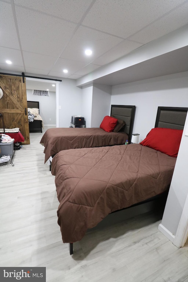 14 Riverside Rd, Dover, DE 19904 - bedroom featuring wood finished floors, a paneled ceiling, and a barn door