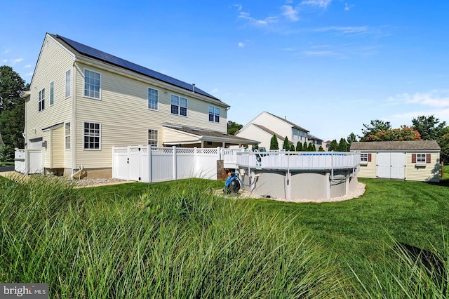 14 Riverside Rd, Dover, DE 19904 - back of property featuring an outdoor pool and a storage shed