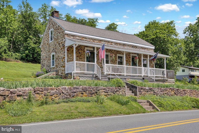 1124 Fairview Dr, Reading, PA 19605 - view of front facade with stone siding, covered porch, a chimney, and a front yard