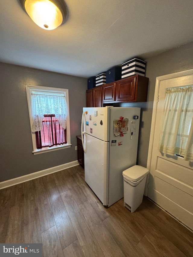 1213 W College Ave, York, PA 17404 - kitchen with freestanding refrigerator, wood finished floors, and baseboards