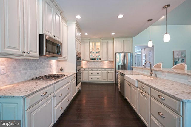 29486 Andrew Jackson Dr, Millsboro, DE 19966 - kitchen featuring appliances with stainless steel finishes, a sink, tasteful backsplash, dark wood-style flooring, and hanging light fixtures