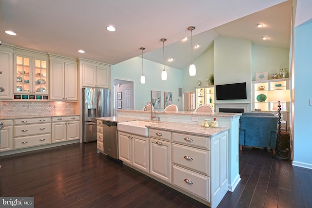 29486 Andrew Jackson Dr, Millsboro, DE 19966 - kitchen featuring appliances with stainless steel finishes, a sink, white cabinetry, dark wood-style floors, and an island with sink