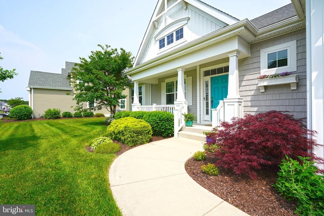 29486 Andrew Jackson Dr, Millsboro, DE 19966 - property entrance featuring a porch, a lawn, and roof with shingles