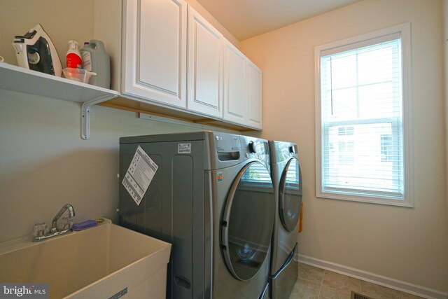 29486 Andrew Jackson Dr, Millsboro, DE 19966 - washroom featuring washer and clothes dryer, cabinet space, baseboards, and light tile patterned flooring
