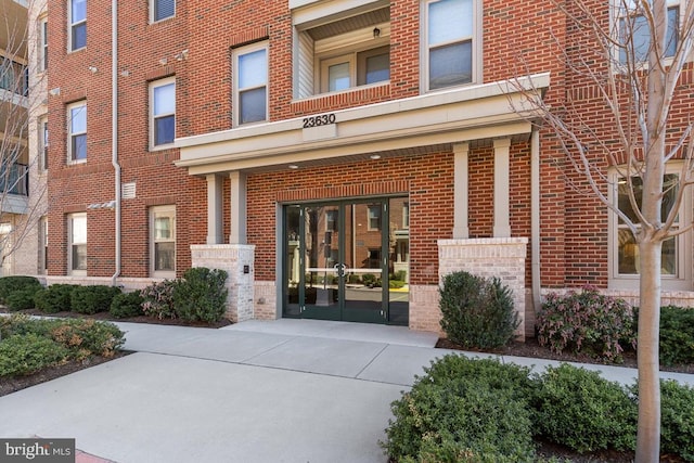 23630 Havelock Walk Ter Unit 205, Ashburn, VA 20148 - view of exterior entry with brick siding and french doors