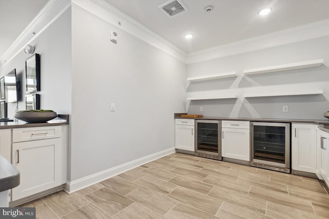 23630 Havelock Walk Ter Unit 205, Ashburn, VA 20148 - indoor dry bar featuring wine cooler, ornamental molding, recessed lighting, baseboards, and wood finish floors