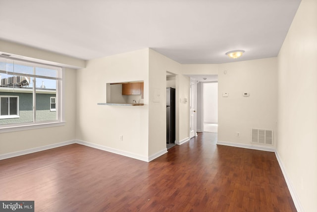 713 Brandywine St SE Unit 303, Washington, DC 20032 - empty room featuring dark wood-style floors and baseboards