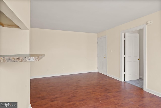 713 Brandywine St SE Unit 303, Washington, DC 20032 - empty room with wood finished floors and baseboards