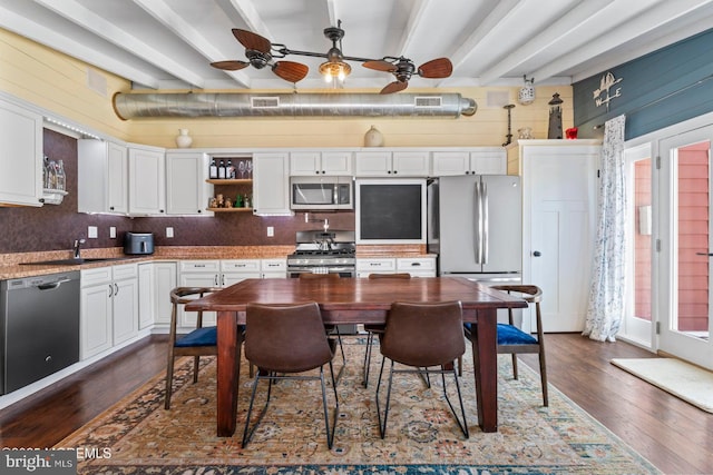 68 Gregg Dr, Manahawkin, NJ 08050 - kitchen with stainless steel appliances, ceiling fan, dark wood-type flooring, white cabinets, and beam ceiling