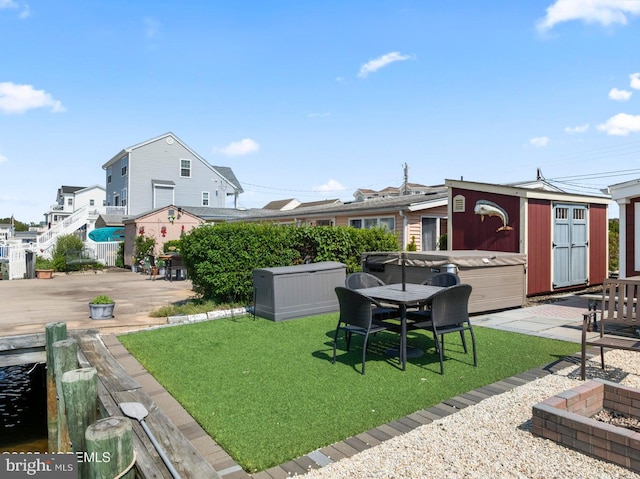 68 Gregg Dr, Manahawkin, NJ 08050 - view of green lawn with a hot tub, a patio, an outdoor structure, and a wooden deck