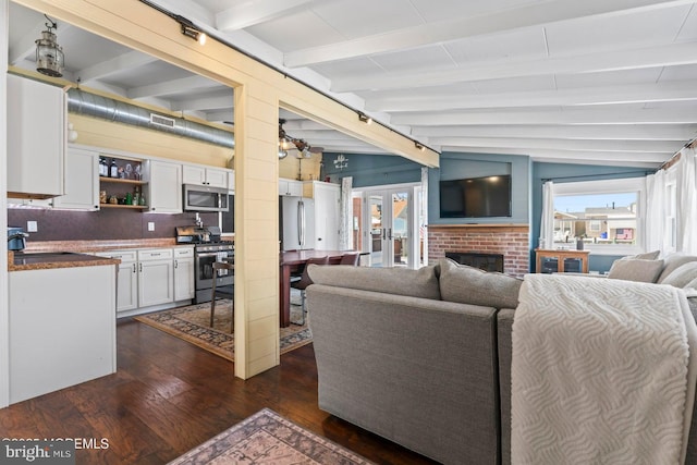 68 Gregg Dr, Manahawkin, NJ 08050 - living area featuring dark wood-style flooring, a brick fireplace, and french doors