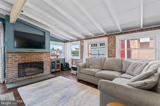68 Gregg Dr, Manahawkin, NJ 08050 - living room with dark wood-style flooring, a brick fireplace, and brick wall