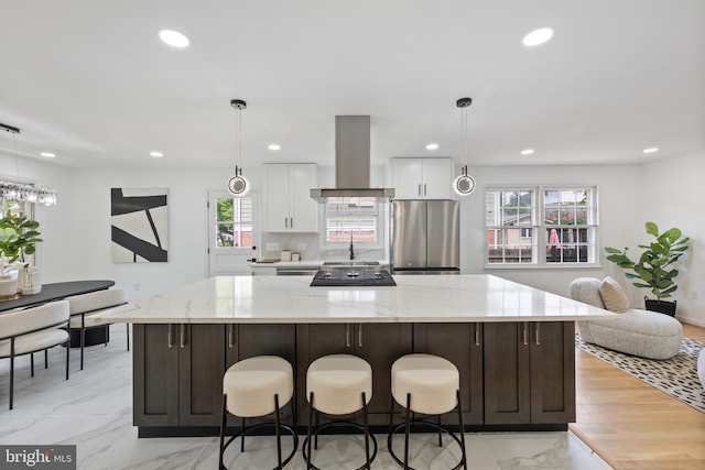1612 Lemontree Ln, Silver Spring, MD 20904 - kitchen with freestanding refrigerator, wall chimney exhaust hood, recessed lighting, white cabinets, and a spacious island