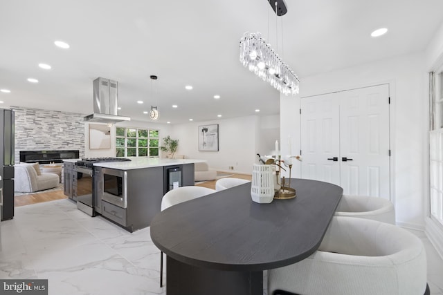 1612 Lemontree Ln, Silver Spring, MD 20904 - dining room featuring recessed lighting, light marble finish floors, wine cooler, and a tiled fireplace