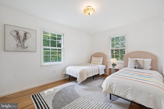 1612 Lemontree Ln, Silver Spring, MD 20904 - bedroom featuring multiple windows, wood finished floors, and baseboards