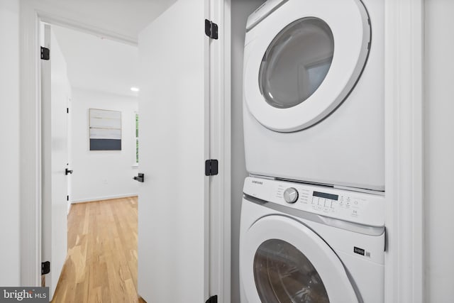 1612 Lemontree Ln, Silver Spring, MD 20904 - laundry area with stacked washer / dryer and light wood-style flooring