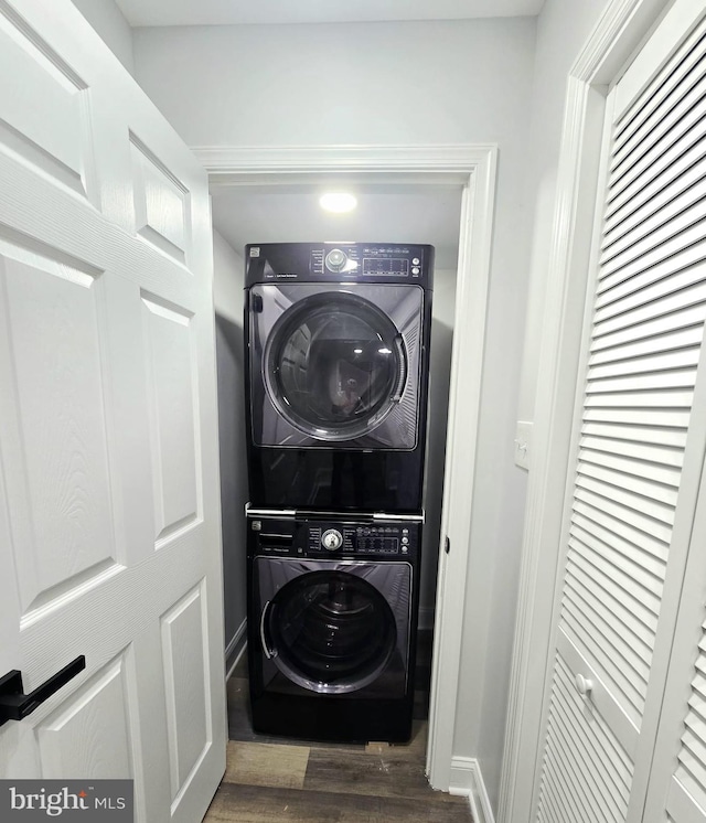 1612 Lemontree Ln, Silver Spring, MD 20904 - laundry room featuring stacked washer and clothes dryer, wood finished floors, and baseboards