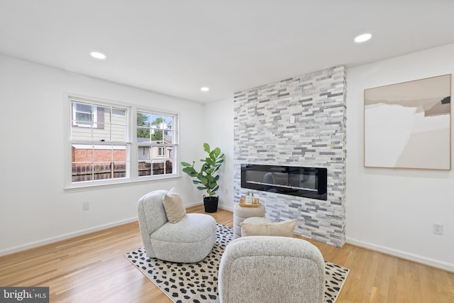 1612 Lemontree Ln, Silver Spring, MD 20904 - sitting room with wood finished floors, baseboards, a large fireplace, and recessed lighting