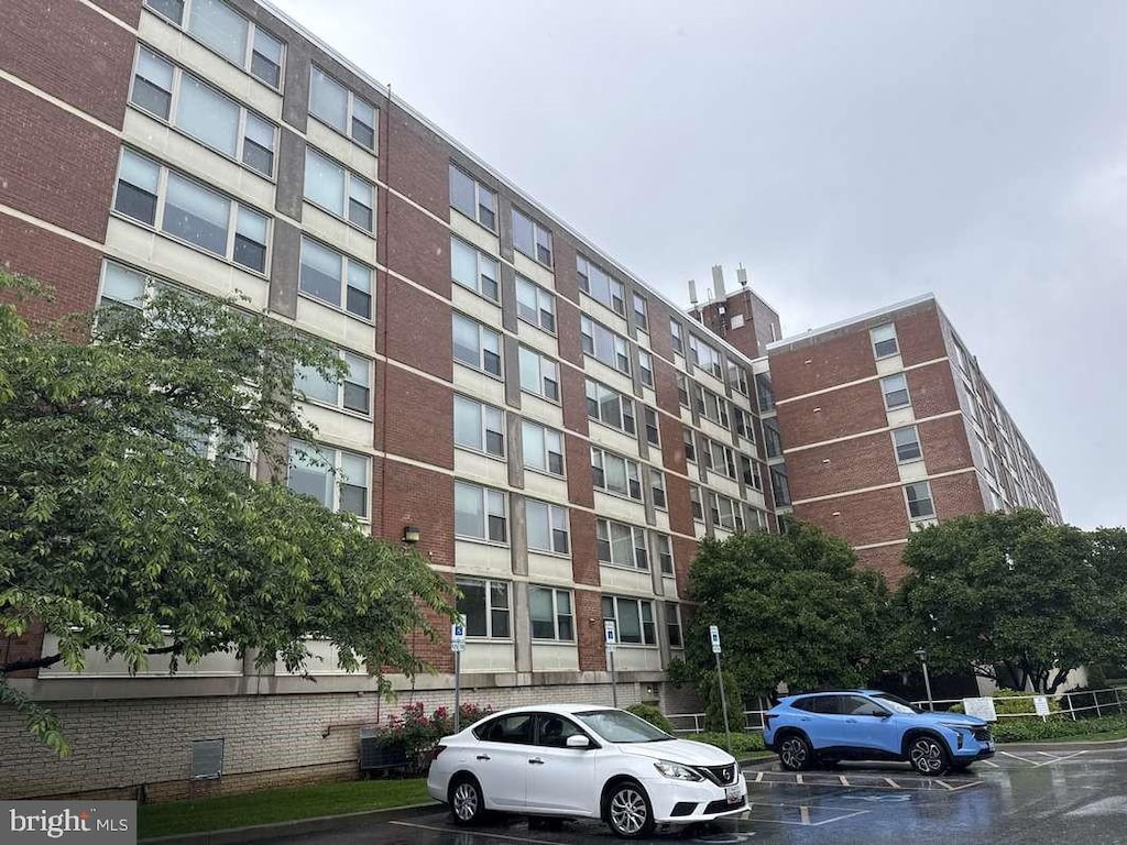 4401 Roland Ave Unit 307, Baltimore, MD 21210 - view of apartment building / complex featuring uncovered parking